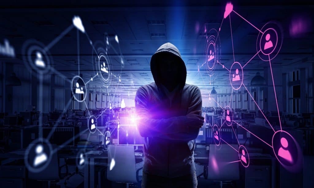 ransomware hacker in a dark room.